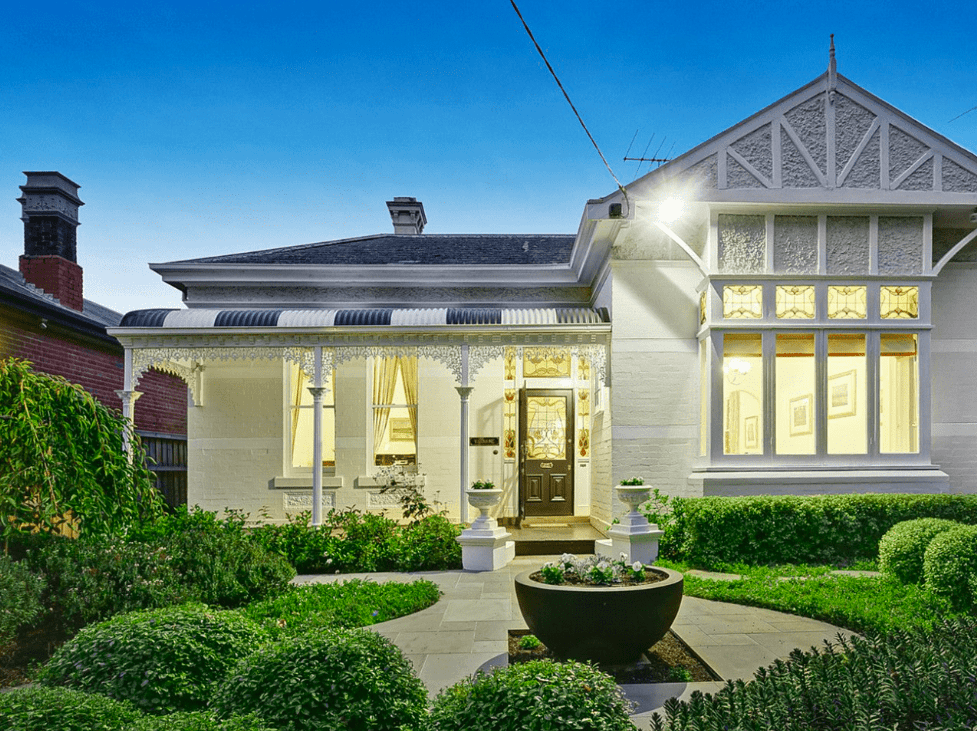 A formal garden design with feature bowl and entry planters tie this landscape design perfectly with the home